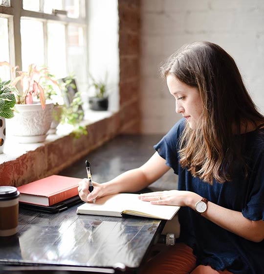 Girl reading a book at a table